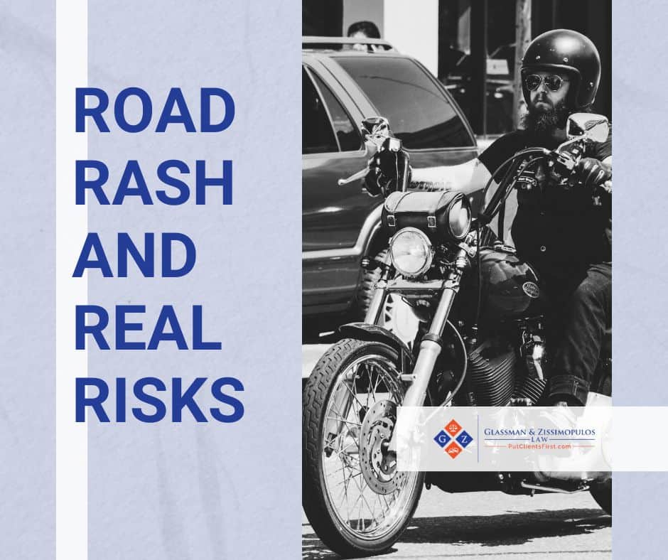 Motorcycle rider wearing safety gear on a city street, illustrating road risks and personal injury concerns for motorcycle accidents.